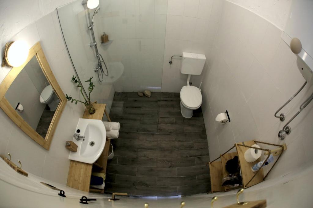a view of a bathroom with a toilet and a sink at Guest house Mediterranea in Pakoštane