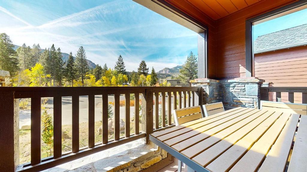 a wooden porch with a wooden bench on a balcony at Cozy Cabin for 8 Close to Eagle Lodge in Mammoth Lakes