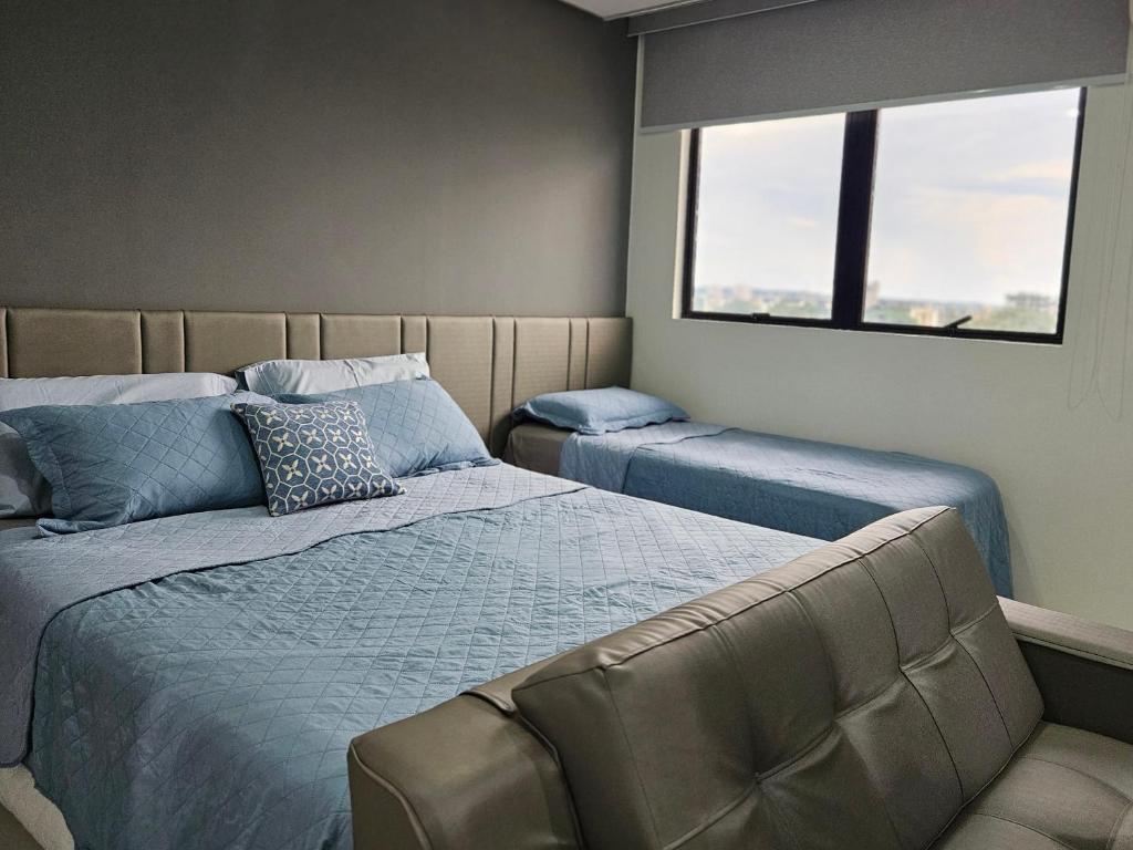 Postel nebo postele na pokoji v ubytování Flat Hotel Millennium