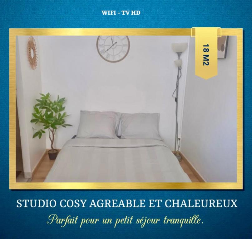 a poster of a bedroom with a bed and a clock at Le minimaliste in Pamiers
