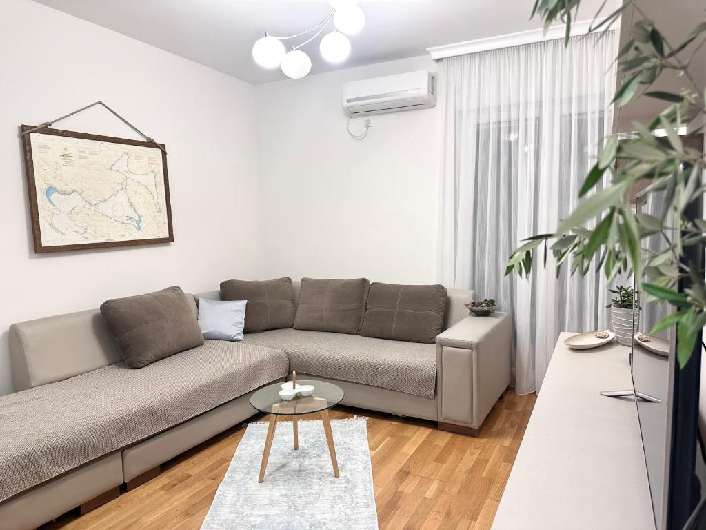 a living room with a couch and a table at Vália in Tivat