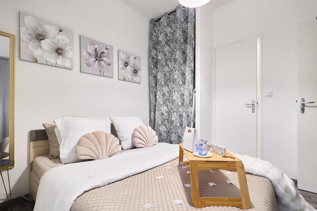 a bedroom with a large bed and a table at Appartement proche centre ville - 1 a 4 personnes in Reims