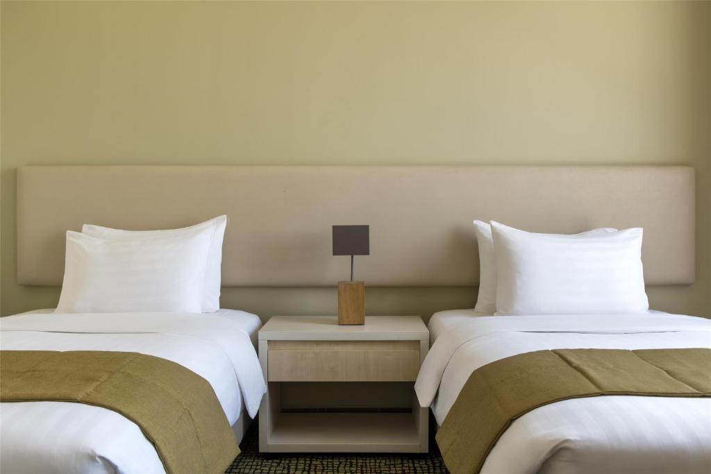 Postel nebo postele na pokoji v ubytování Bristoria Hotel Erbil