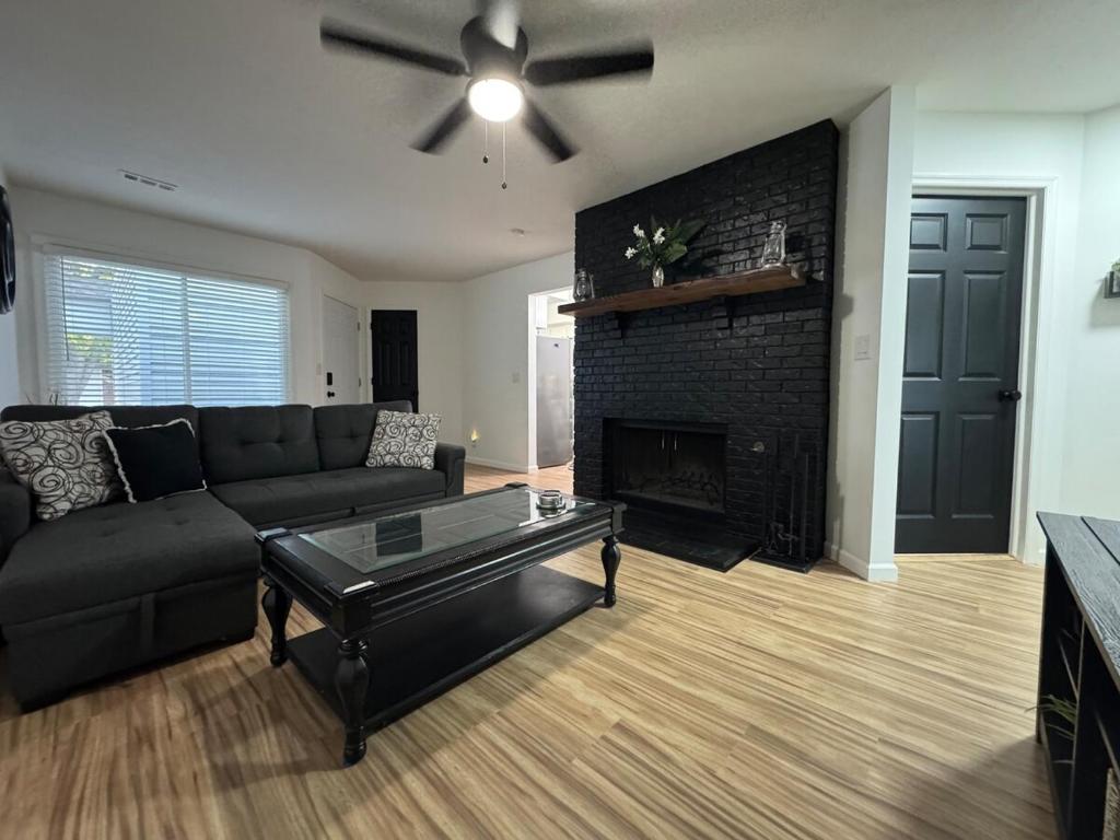 a living room with a couch and a fireplace at Contemporary Cutie in Lincoln