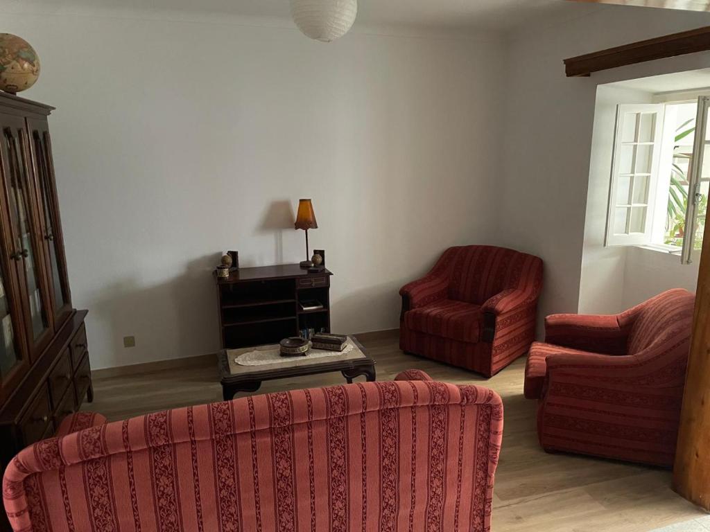 a living room with two chairs and a table at Casa na praia- Maia in Maia