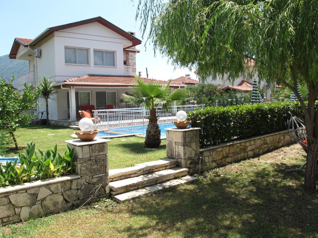 a house with a fence and a swimming pool at Crescent Villa in Dalyan