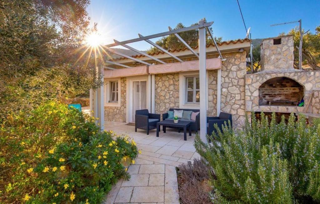 a stone house with a patio with a pizza oven at Holiday house with a parking space Sveti Jakov, Losinj - 24017 in Sveti Jakov