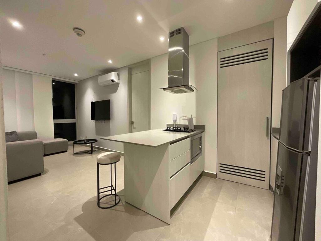 a kitchen with a counter and a refrigerator in a room at Exclusivo Apartamento en Distrito 90 in Barranquilla