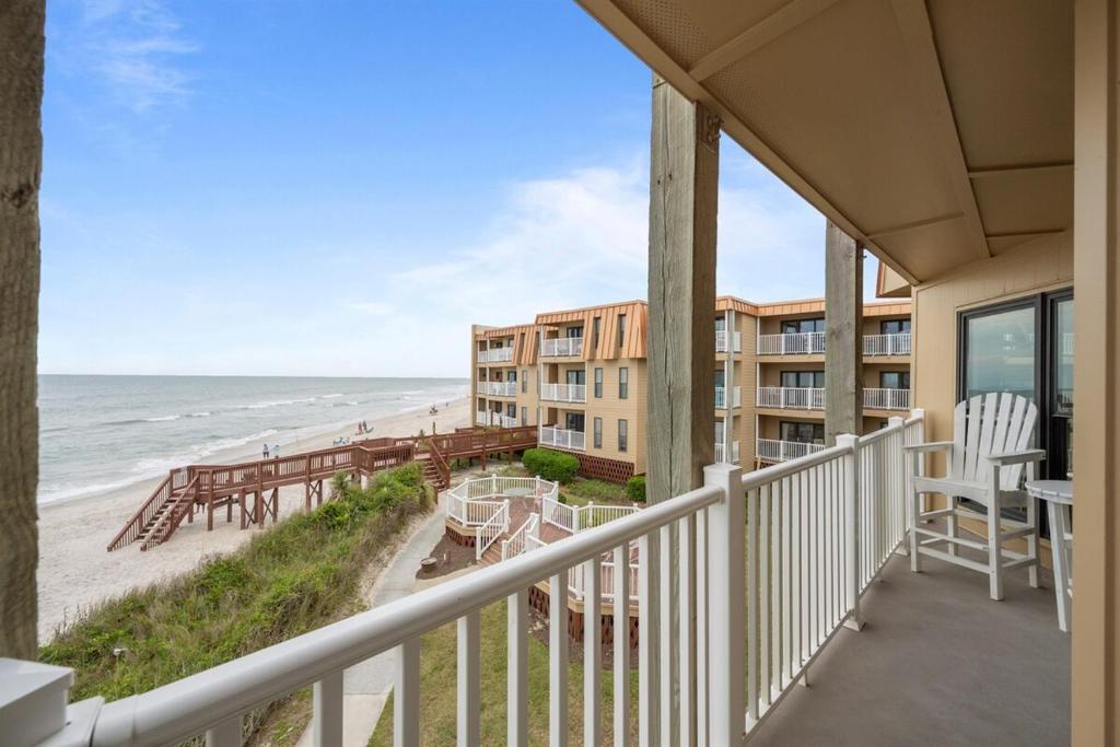 a balcony of a condo with a view of the beach at Sea La Vie- Oceanfront Family Retreat in North Topsail Beach