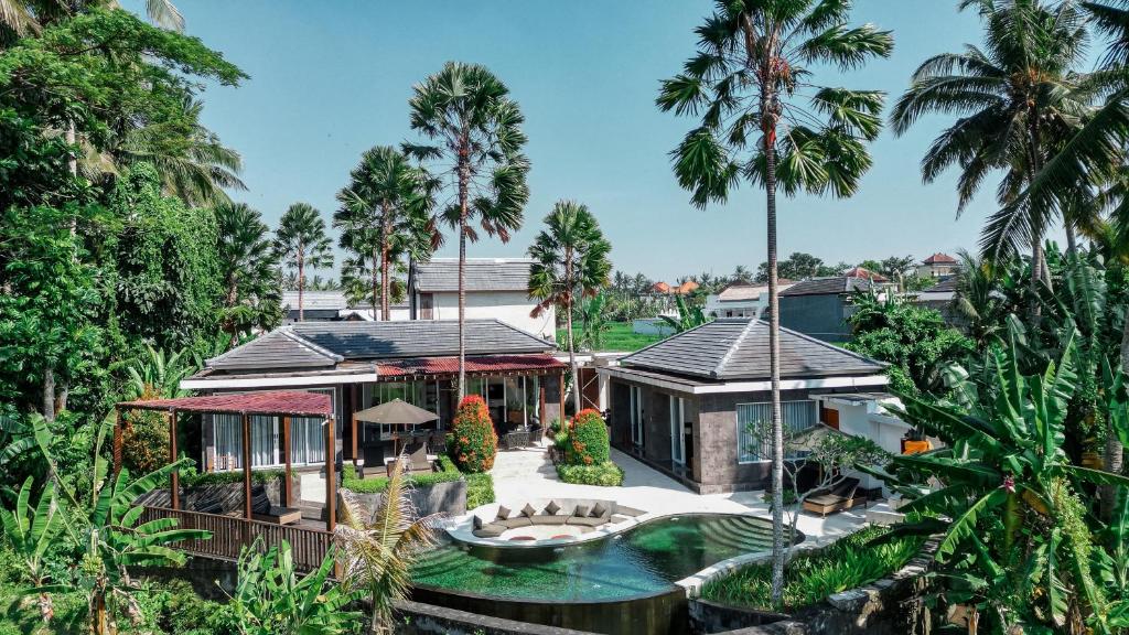 an aerial view of a house with a pool and palm trees at Coconut Grove 3BR Villa Pool Ubud in Ubud