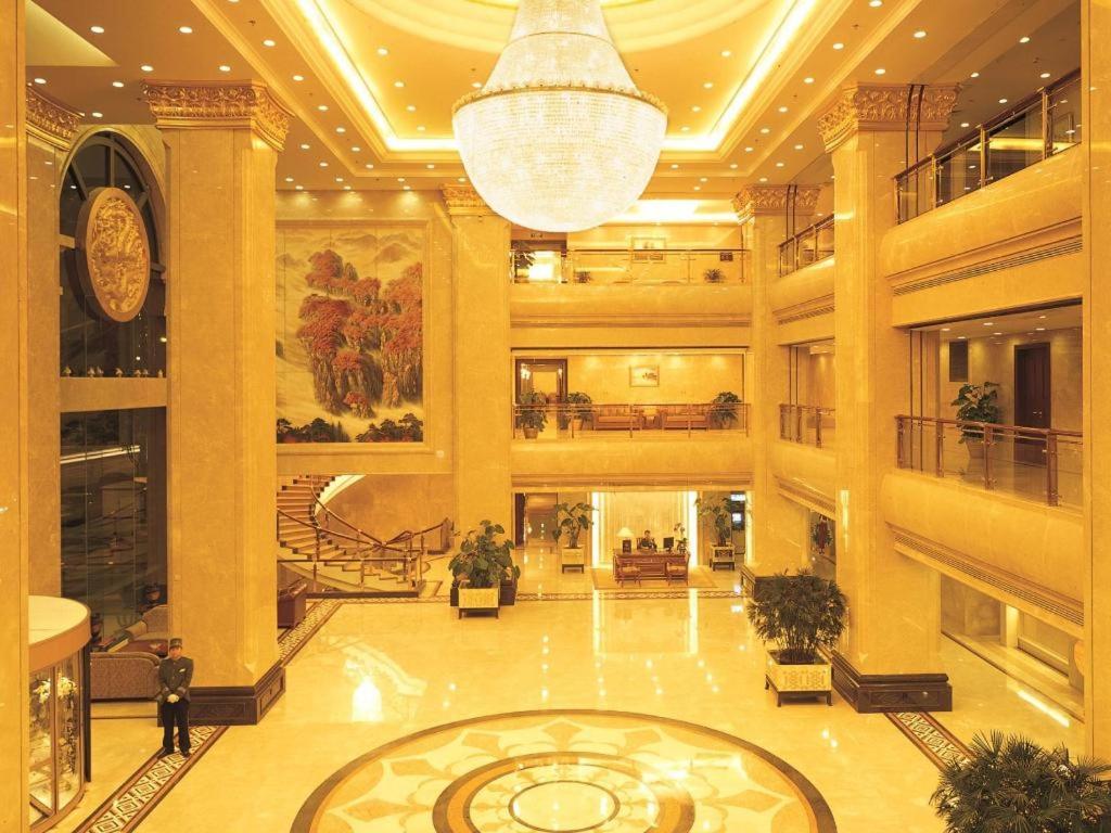 a large lobby with a chandelier in a building at Xinhai Jinjiang Hotel in Beijing