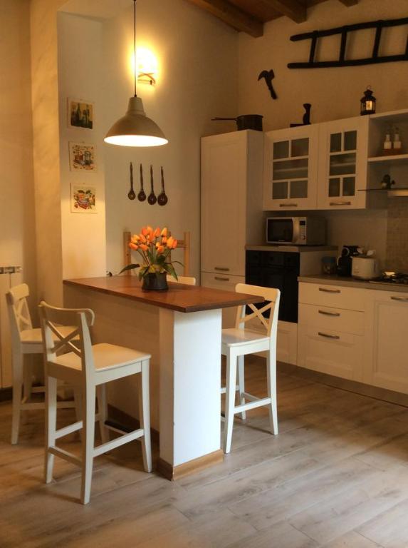 a kitchen with a island with chairs and a table at Casa Vacanze Ada in Fiesole
