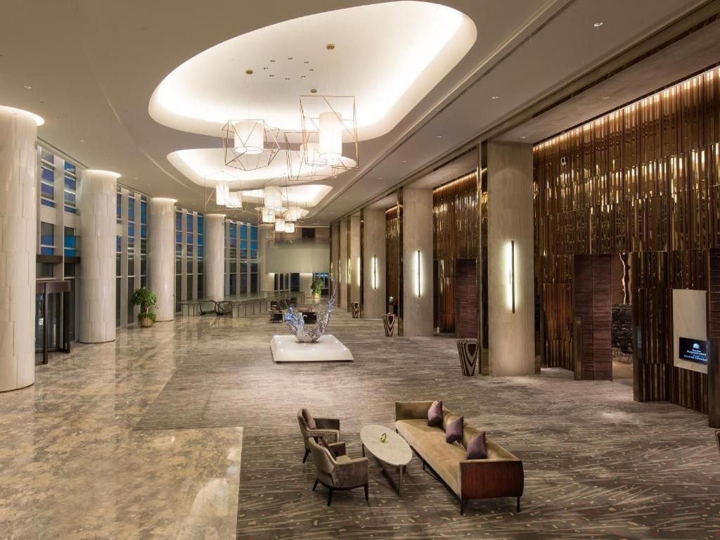 una hall con divani e sedie in un edificio di Sunrise Kempinski Hotel Beijing a Xizhuang