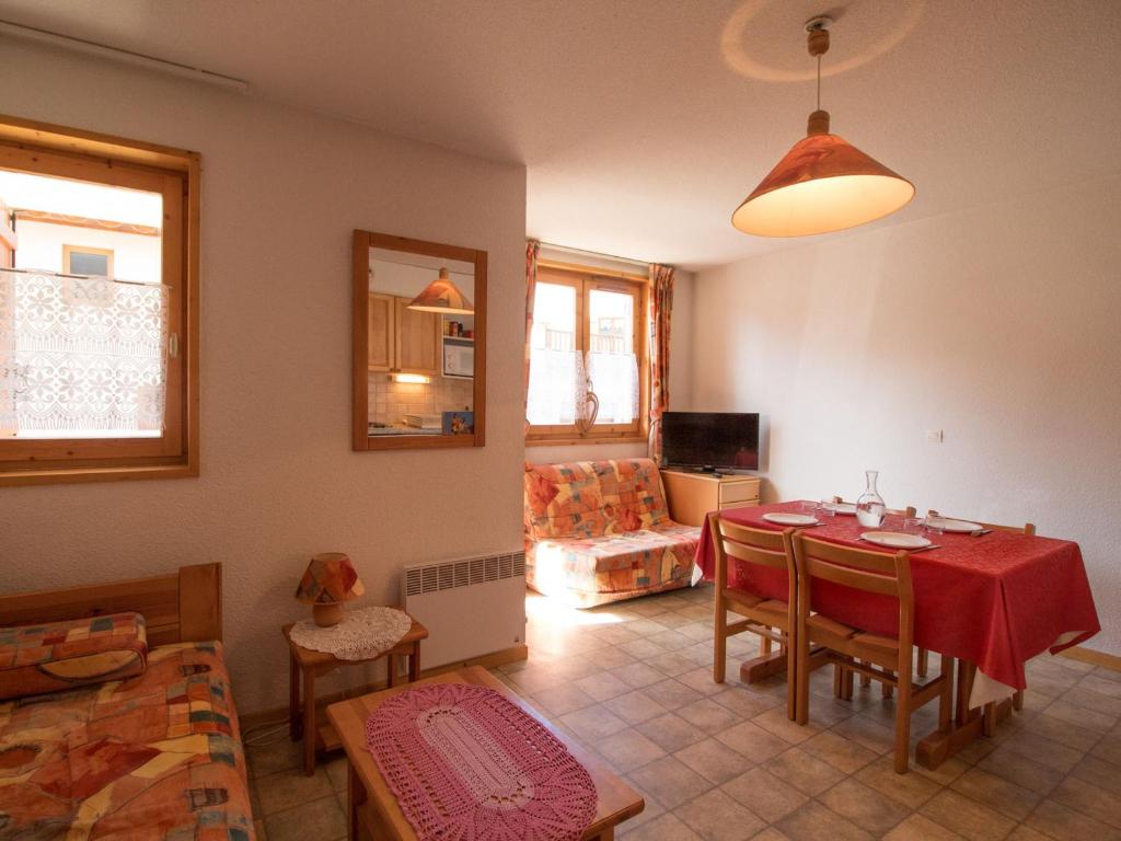 a living room with a table and a couch at Appartement confortable 3/4 pers à Aussois - FR-1-508B-18 in Aussois