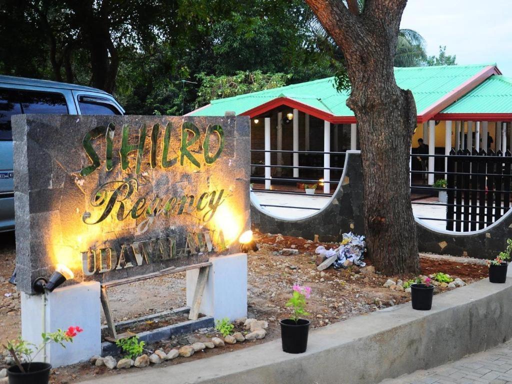a sign that says shilimp therapy next to a tree at Sihilro Regency Hotel in Udawalawe