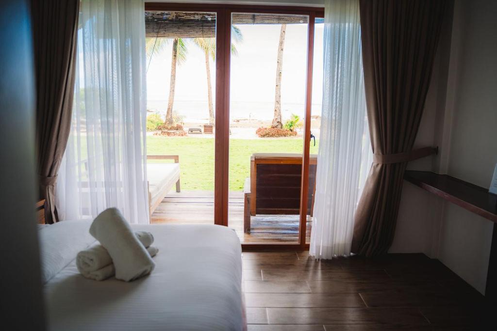 Postel nebo postele na pokoji v ubytování Woody's Place Siargao