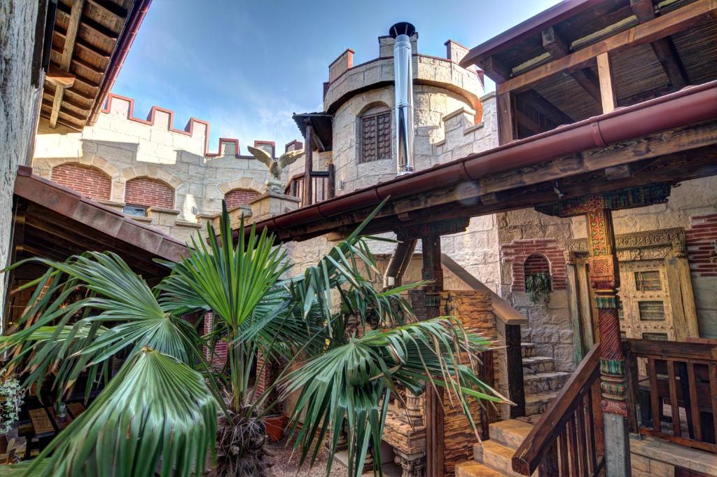 a building with palm trees in front of it at Vaya Casa in Kappelrodeck