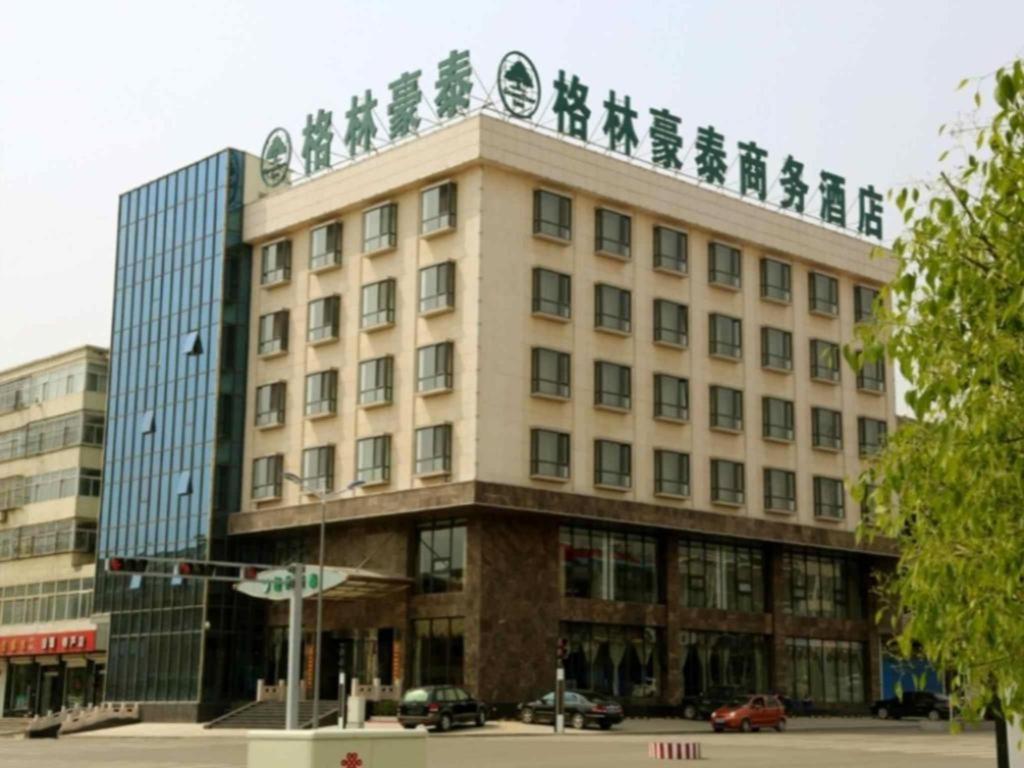 a building with chinese writing on the top of it at GreenTree Inn JiangSu DingShu Twon JieFang(E) Road Express Hotel in Zhoushu