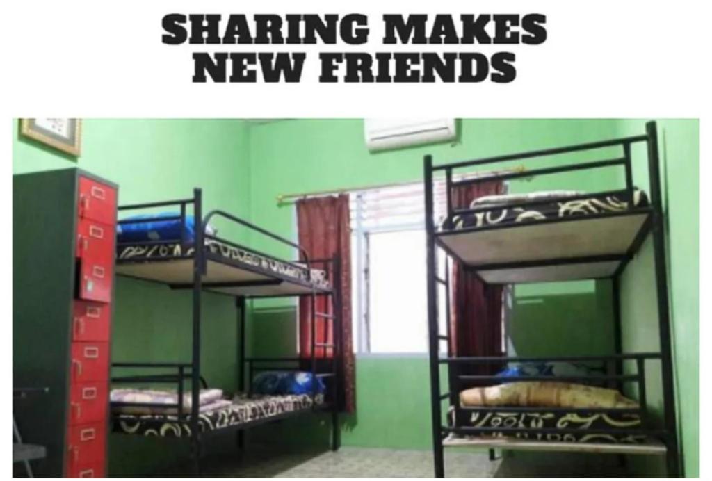 Postel nebo postele na pokoji v ubytování Medan Dazhong Backpacker's Hostel