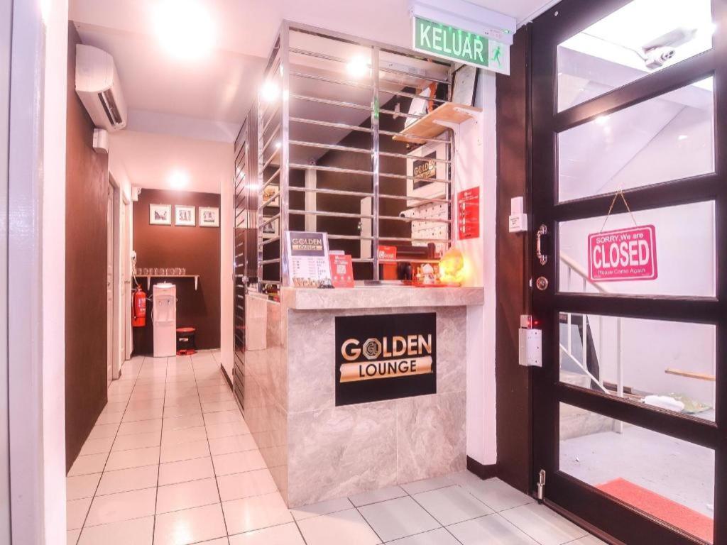 a restaurant with a golden lounge sign on a counter at OYO 89465 Golden Lounge in Kuching