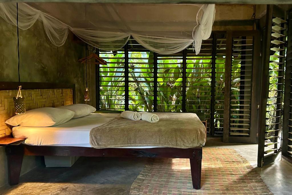a bedroom with a bed with two towels on it at LOA Stay in Surigao