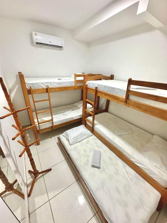 a room with three bunk beds in it at Quarto 04 - Pousada Canaã in Recife
