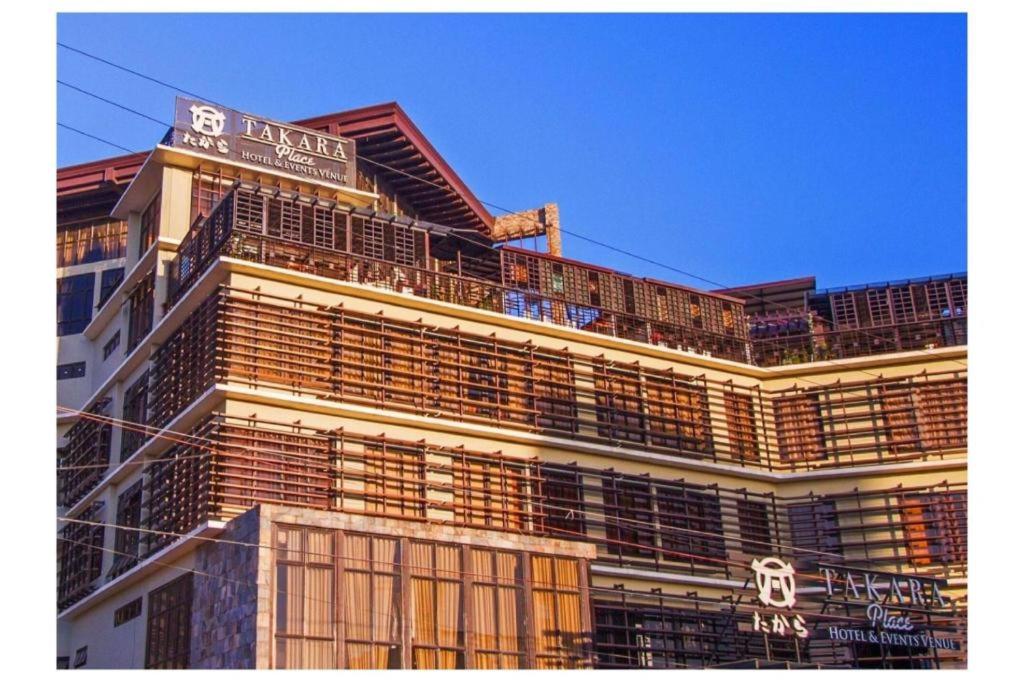 a building with a sign on top of it at Capital O 897 Takara Hotel And Events Place in Calamba