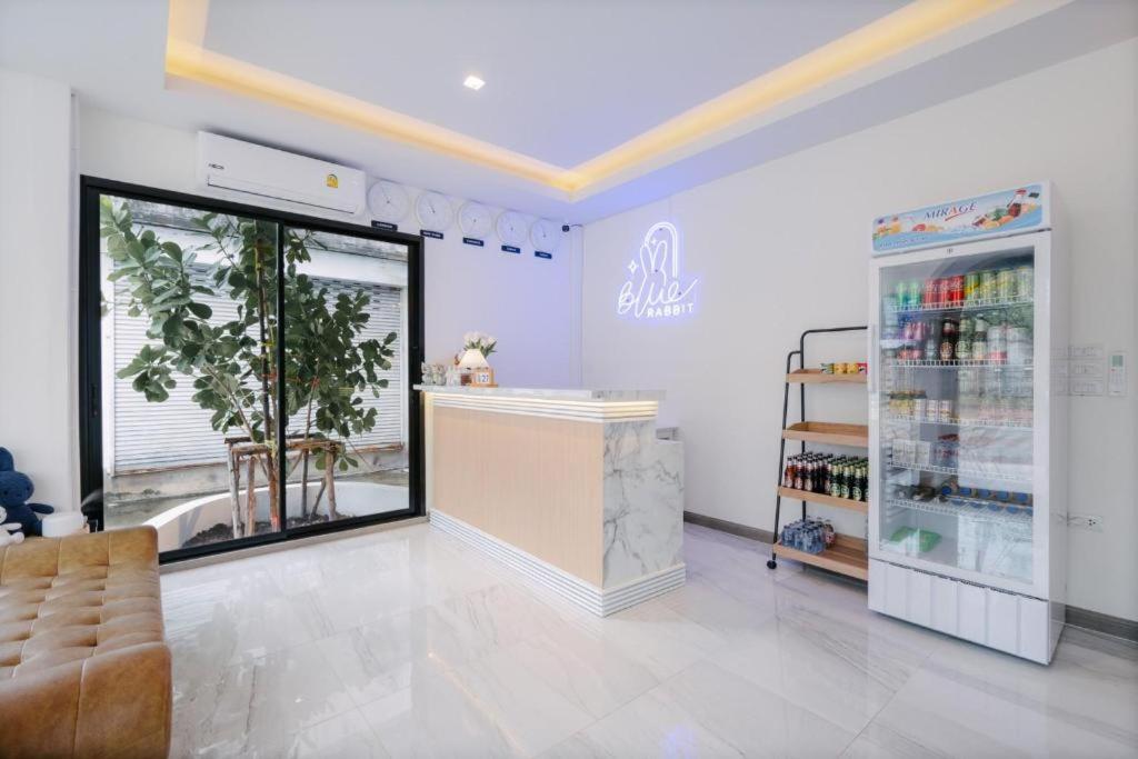 a store with a counter and a refrigerator at Blue rabbit phuket in Ban Tha Khreng