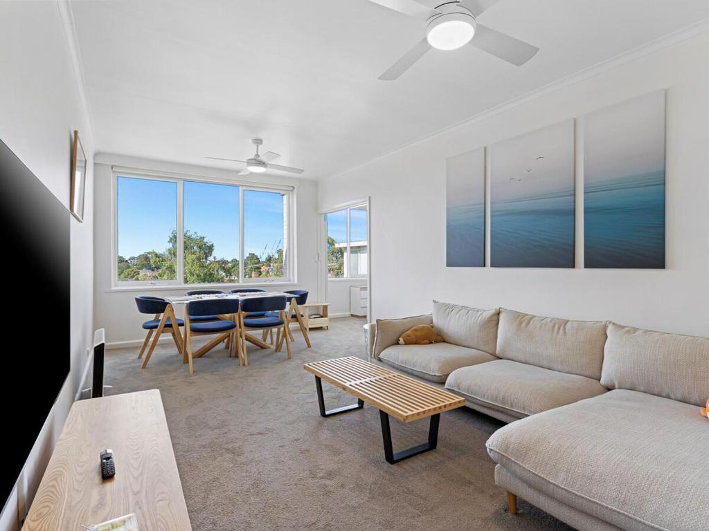 a living room with a couch and a table at Stylish South Yarra Escape & Free Parking in Melbourne