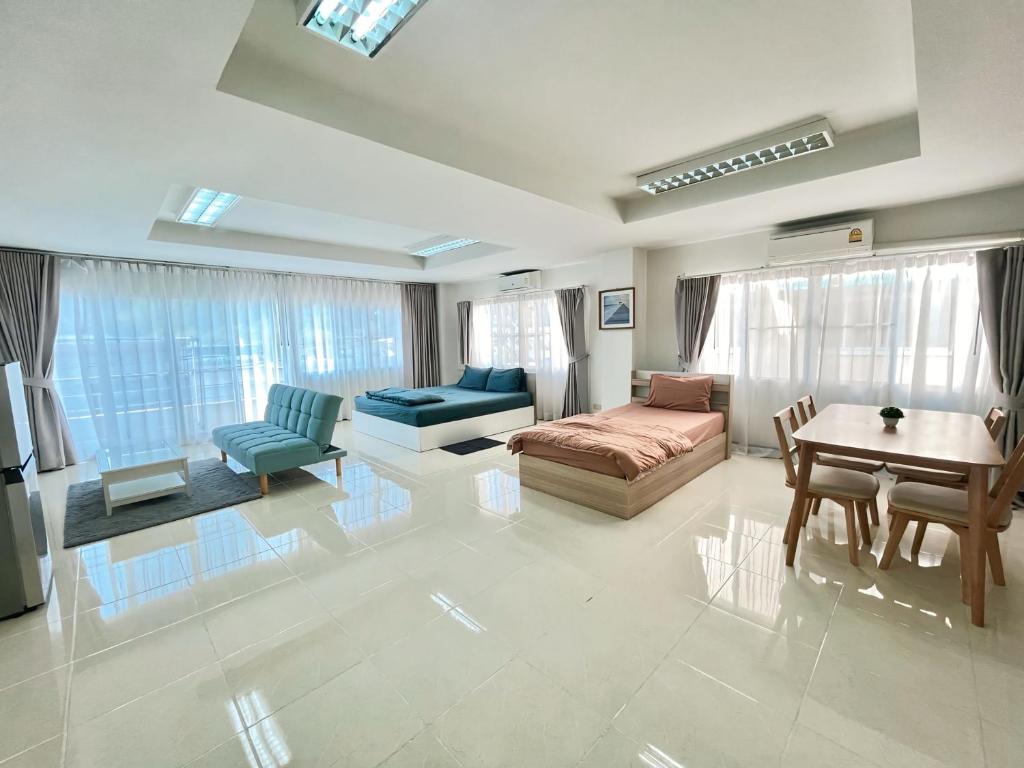 a large living room with a bed and a table at TONY Central Stay in Phuket Town