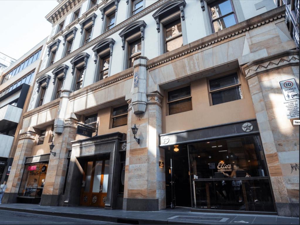 a building on the corner of a city street at Flinders Lane City Apartment Superior Studio in Melbourne