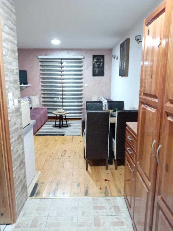 a kitchen and living room with a couch and a table at Simic Apartmani Tara in Kaludjerske Bare