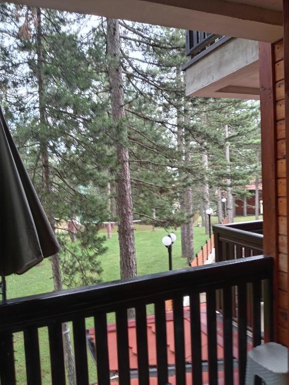 a screened in porch with a view of the trees at Simic Apartmani Tara in Kaludjerske Bare
