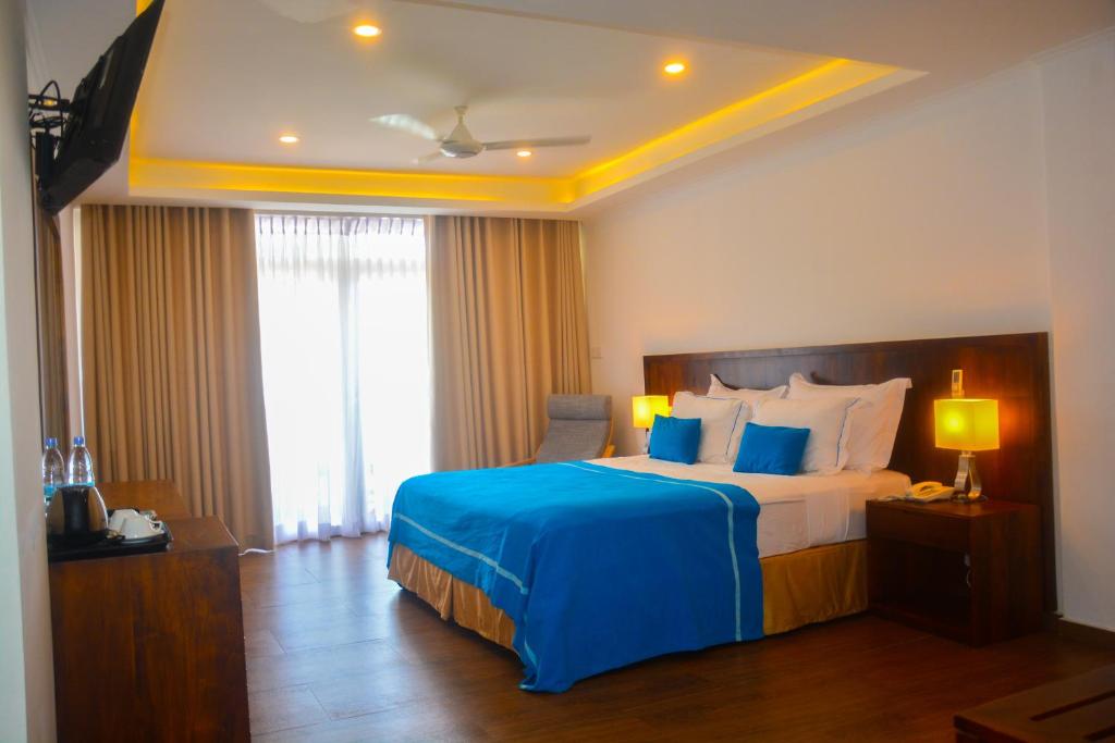 Postel nebo postele na pokoji v ubytování Sayura Beach Hotel