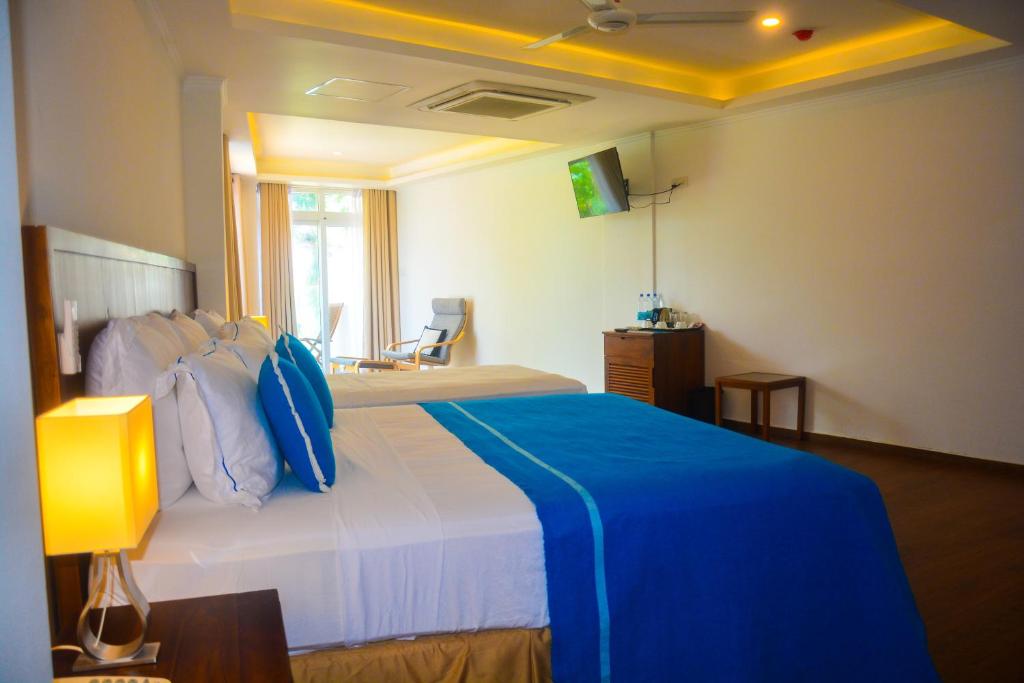 Postel nebo postele na pokoji v ubytování Sayura Beach Hotel