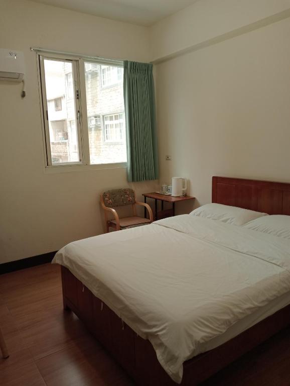 Postel nebo postele na pokoji v ubytování 星海芝家民宿Samuel's Home