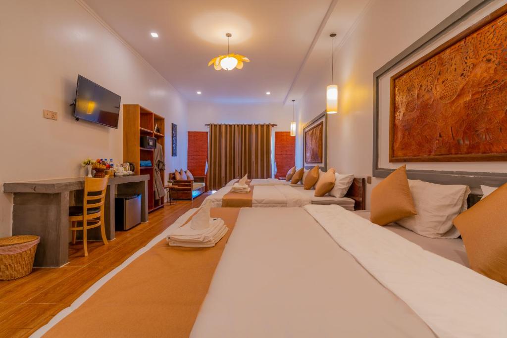 Postel nebo postele na pokoji v ubytování Angkor Rithy Residence