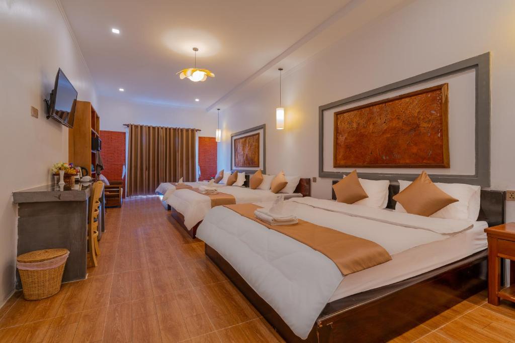 Postel nebo postele na pokoji v ubytování Angkor Rithy Residence