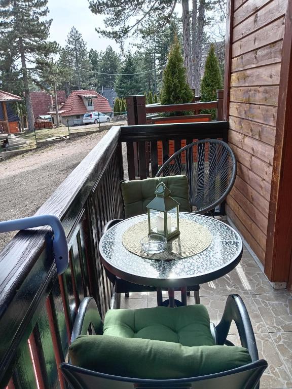 a table and chairs sitting on a balcony at Simic Apartmani Tara in Kaludjerske Bare