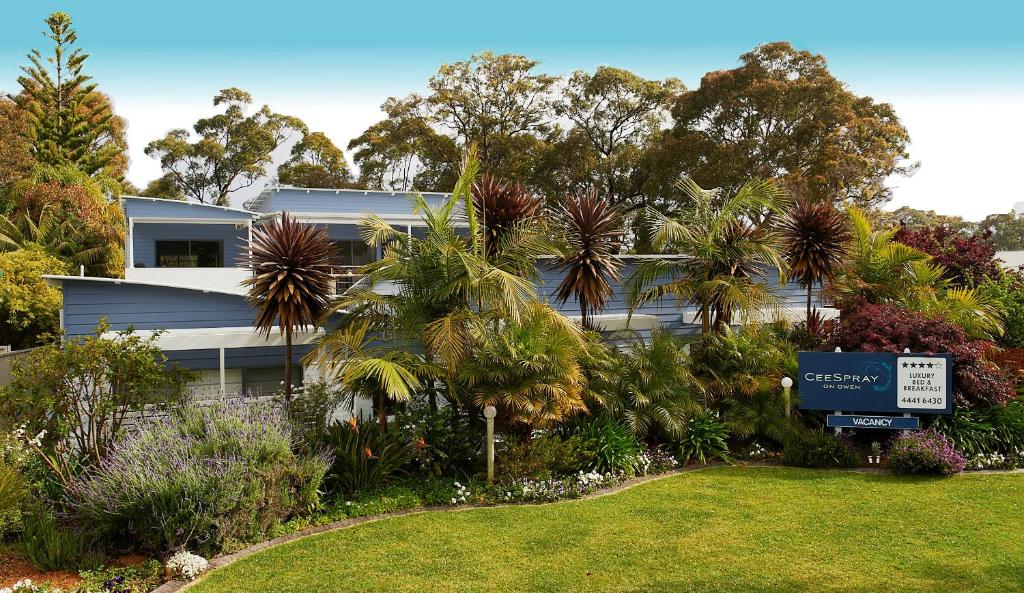 a house with a sign in front of a yard at CeeSpray - Accommodation in Huskisson - Jervis Bay in Huskisson