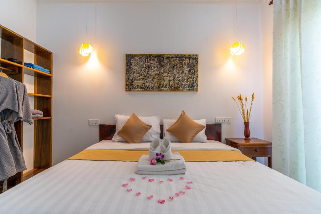 Postel nebo postele na pokoji v ubytování Angkor Rithy Residence