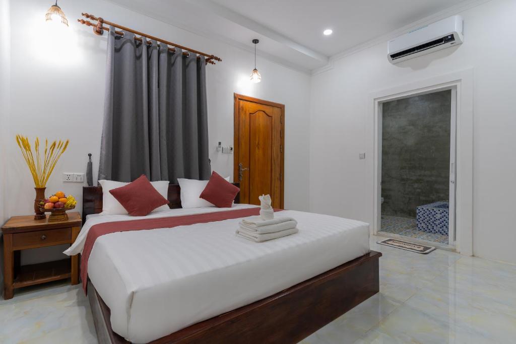 Postel nebo postele na pokoji v ubytování Angkor Rithy Residence