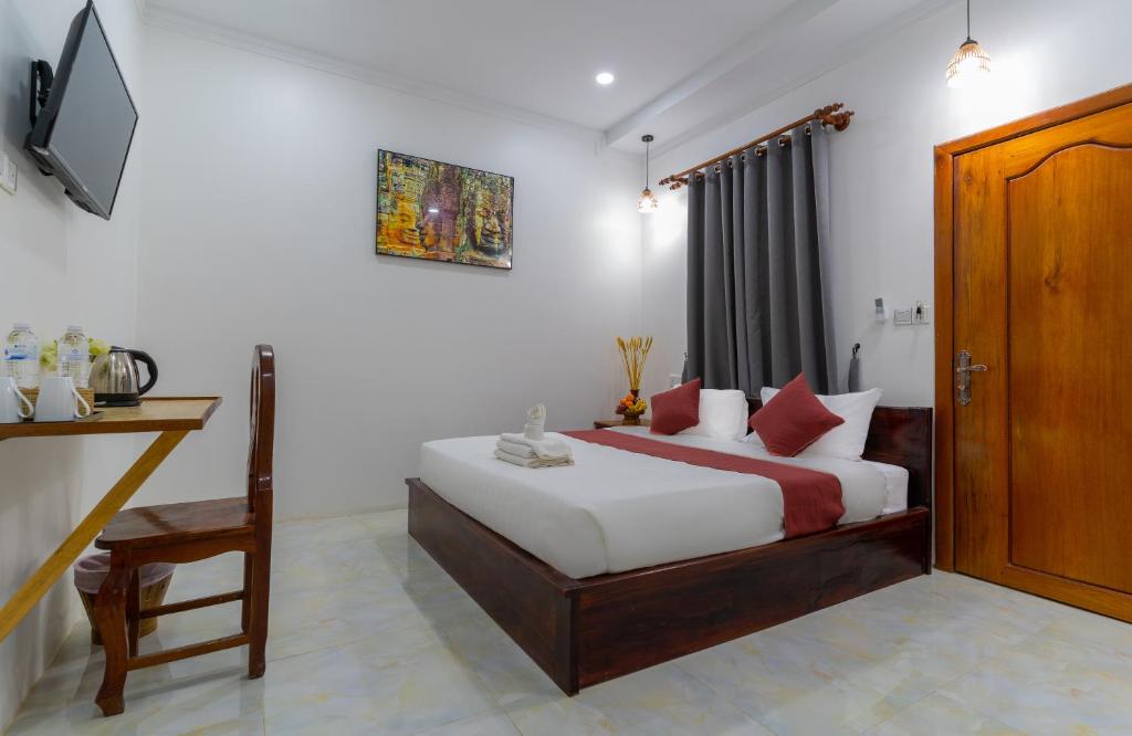 Postel nebo postele na pokoji v ubytování Angkor Rithy Residence