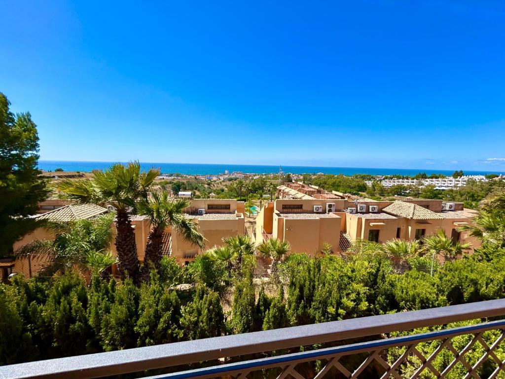 a view from the balcony of a home with palm trees at Luna-Villa de Riviera with Sea-View in Mijas Costa