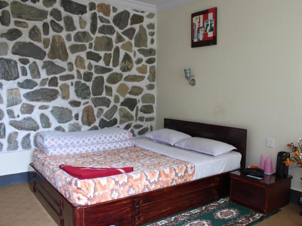 Postel nebo postele na pokoji v ubytování Stupa Resort