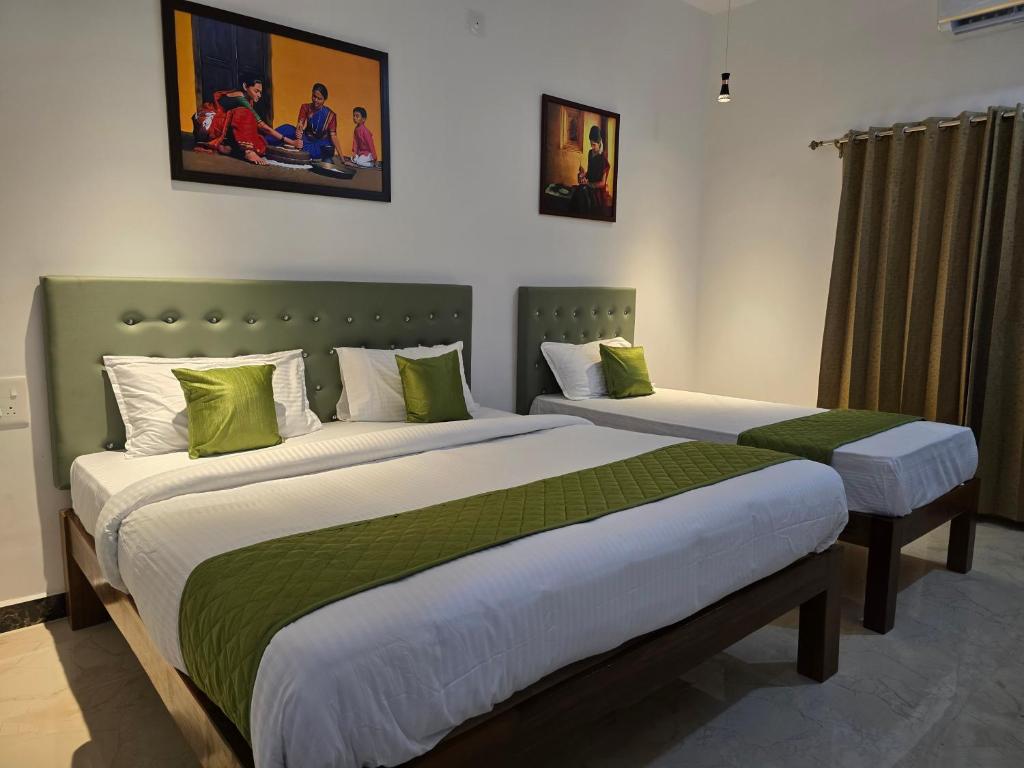 Postel nebo postele na pokoji v ubytování De Asian Resort Pondicherry