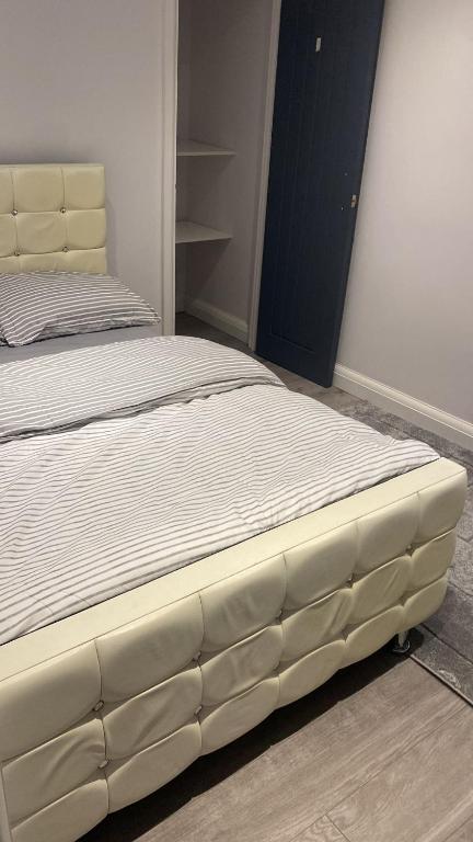 a bed in a bedroom with a white mattress at Abena' Villa in Moffat