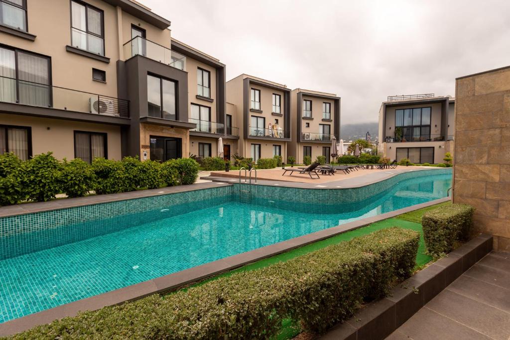 an image of a swimming pool in a apartment building at Kervansaray Two Bed Apartment by HolidayKeys in Kyrenia