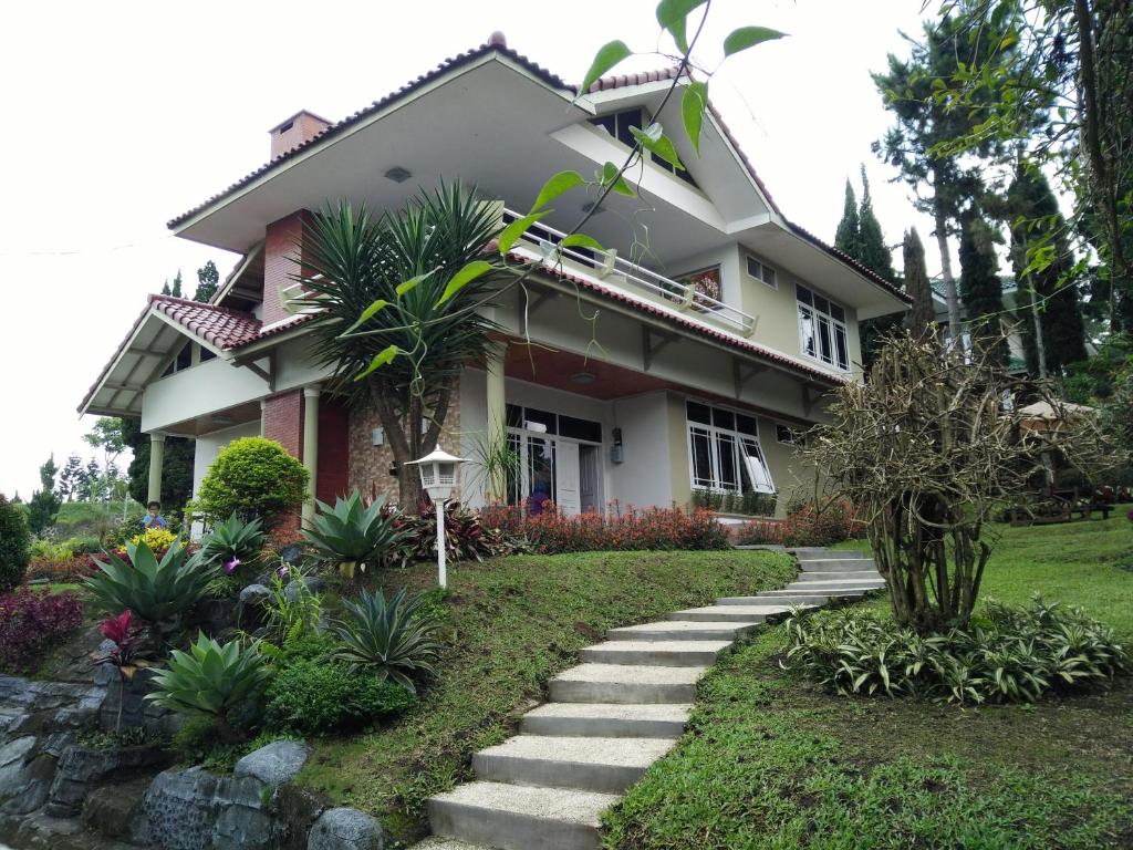 a house with a pathway in front of it at Villa Bougenvile Lembang Asri in Lembang