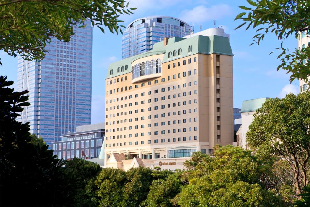 a tall building in a city with tall buildings at Hotel Francs in Chiba